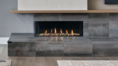 Large fireplace with a 50" linear burner. The clean uninterrupted view of the flame is enhanced by two sides of viewing and is zero clearance for design flexibility.