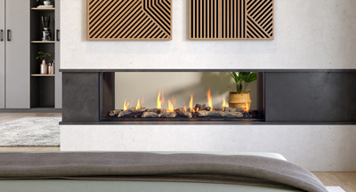 Large fireplace with a 60" linear burner. The clean uninterrupted view of the flame is enhanced by two sides of viewing allowing for the fire to be enjoyed in two rooms and is zero clearance for design flexibility.